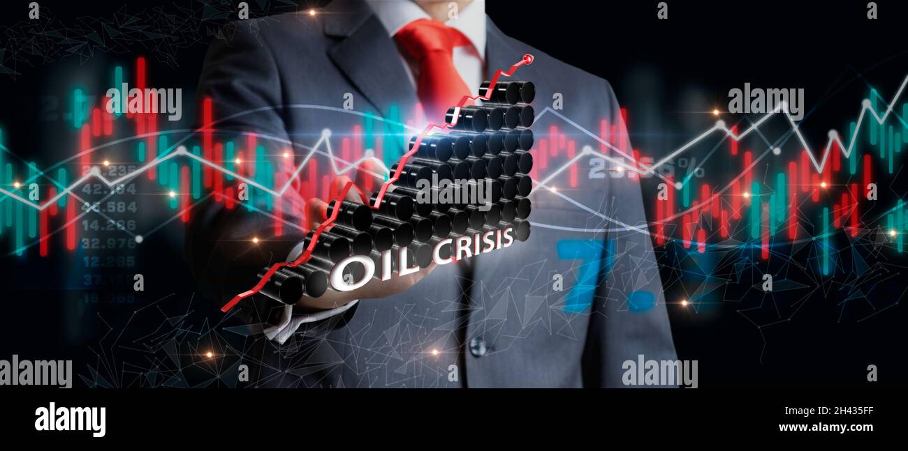 Imprenditore che detiene un gruppo di barili di petrolio con grafici del mercato azionario come concetto di materia prima. Concetto di crisi finanziaria mondiale. Giù di oi Foto Stock
