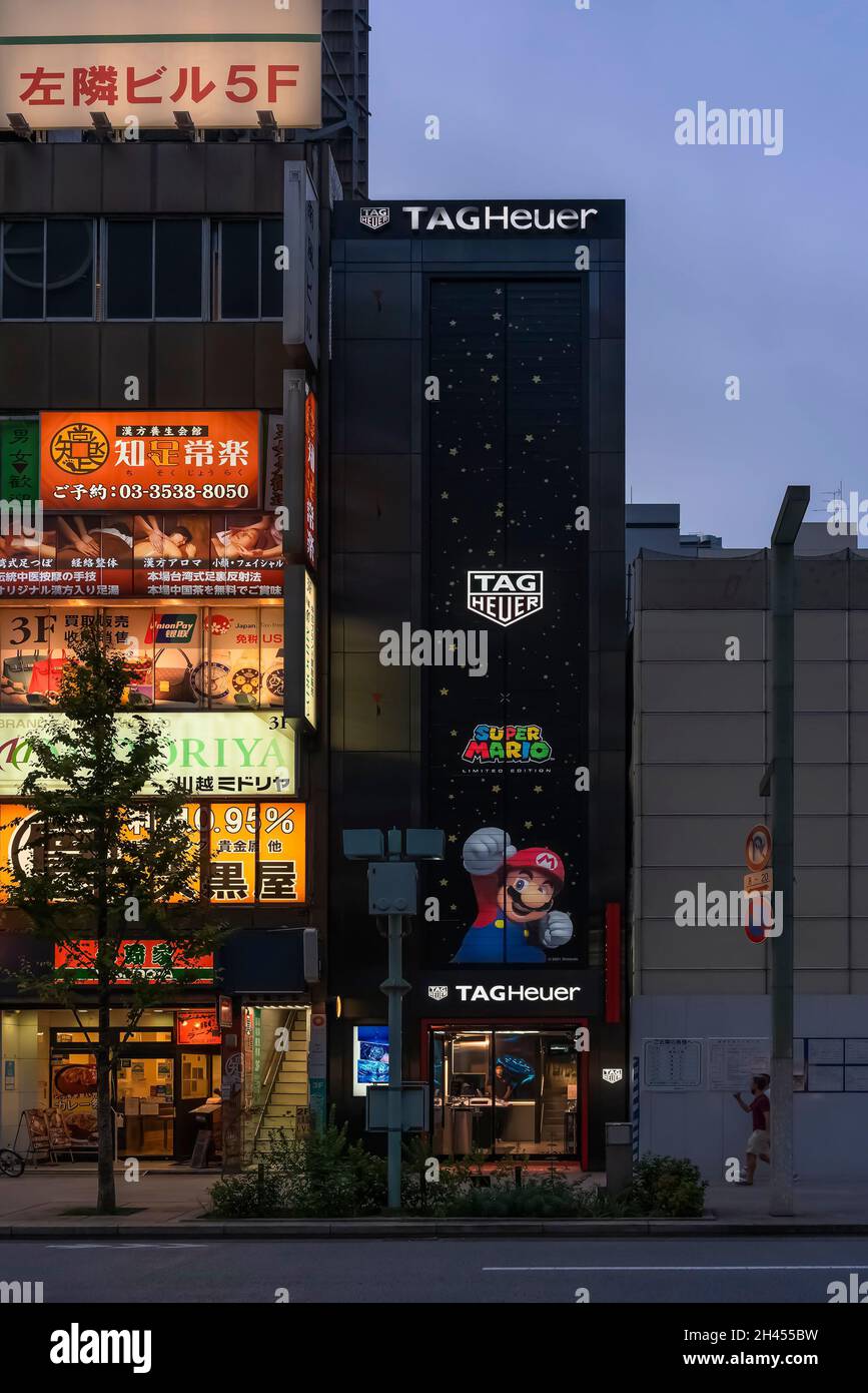tokyo, giappone - agosto 24 2021: Cartelli illuminati sulla facciata del TAG Heuer Ginza Boutique adornato con il famoso Nintendo game c Foto Stock