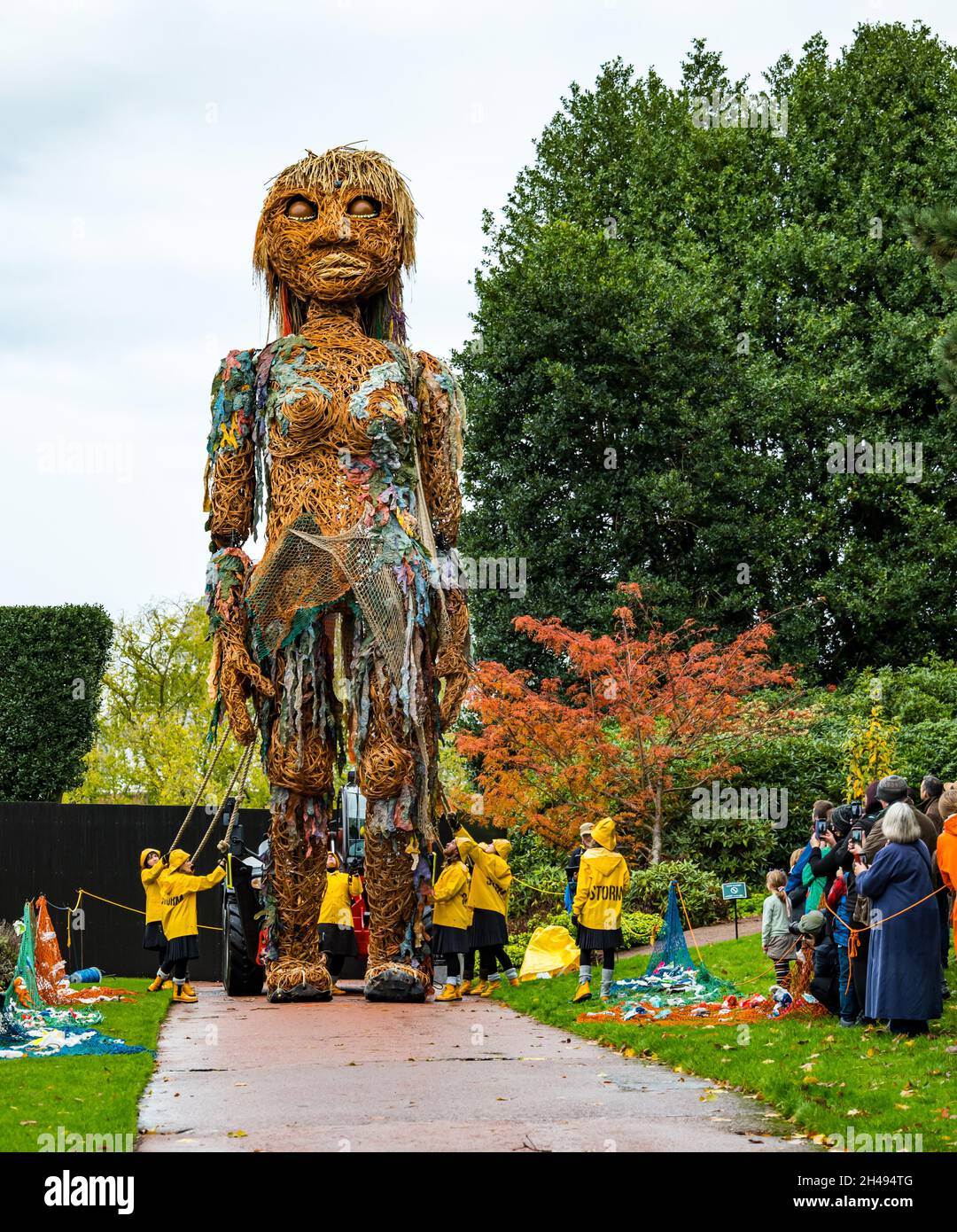 La gente guarda la tempesta di burattini giganti, fatta dai materiali riciclati, al Royal Botanic Garden, Edimburgo, Scozia, Regno Unito Foto Stock