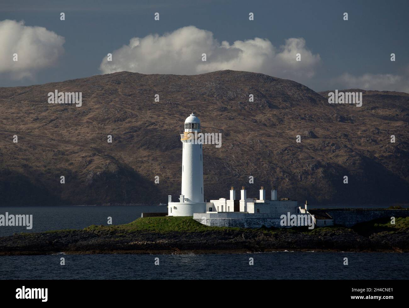 Eilean Musdile (Mansedale) isoletta e faro a sud-ovest di Lismore nelle Ebridi interne Foto Stock