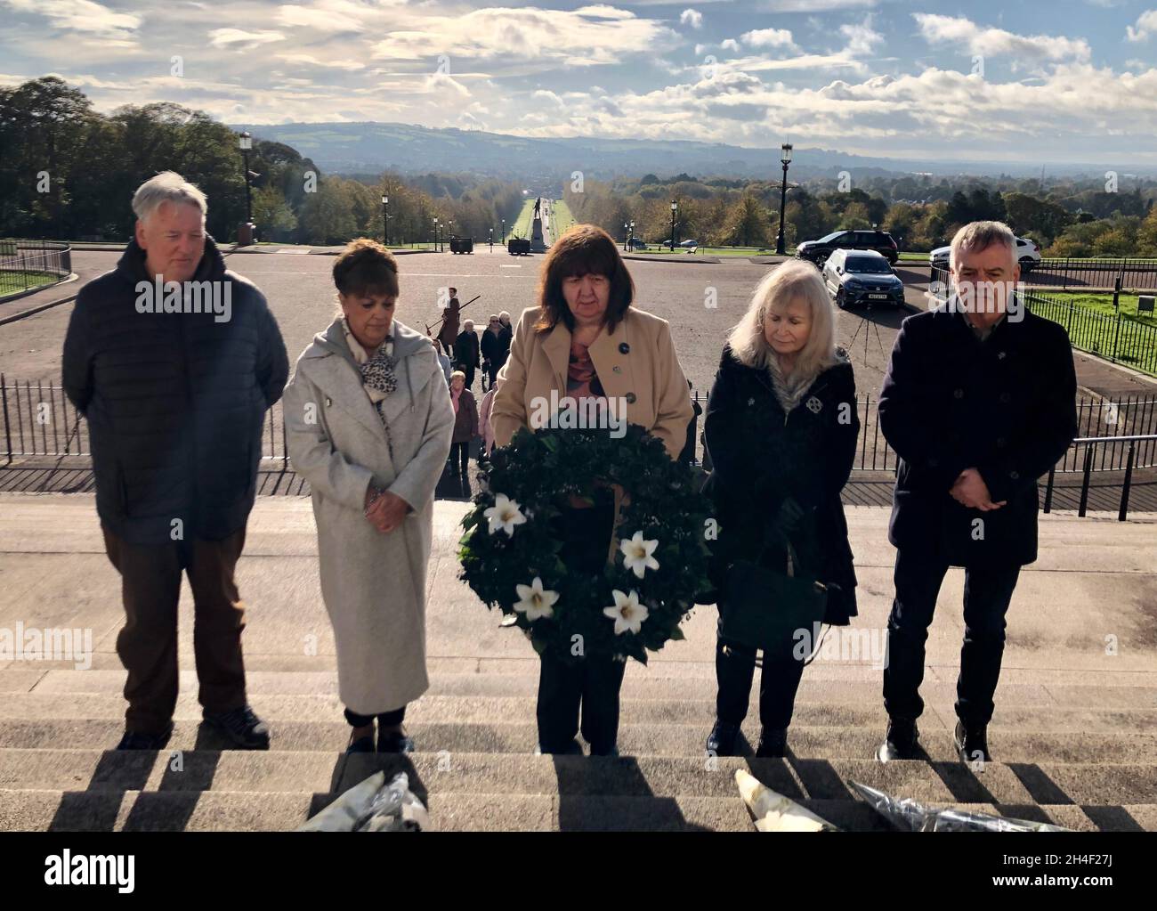 I parenti prendono parte a una camminata silenziosa e a una corona che si stendono il giorno di All Souls per le vittime scomparse dei problemi dell'Irlanda del Nord, al di fuori degli edifici del Parlamento, Stormont, Belfast. Data foto: Martedì 2 novembre 2021. Foto Stock