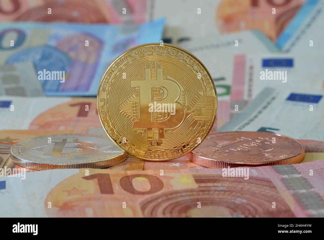 Monete in Bitcoin, banconote in euro Foto Stock