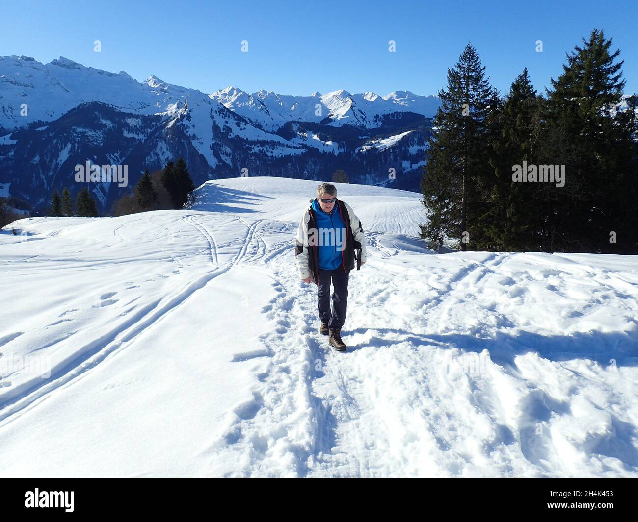 Uomo a piedi nella neve, Mt Mythen, Svizzera Foto Stock