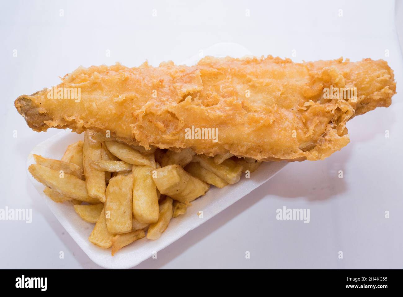 Cucina tradizionale britannica: Merluzzo bianco o eglefino fritto in pastella, servito con patatine Foto Stock