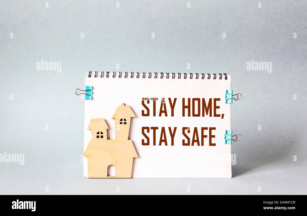 Blocco note con le parole Stay Home stare AL SICURO, Covid-19 concetto di prevenzione del coronavirus Foto Stock