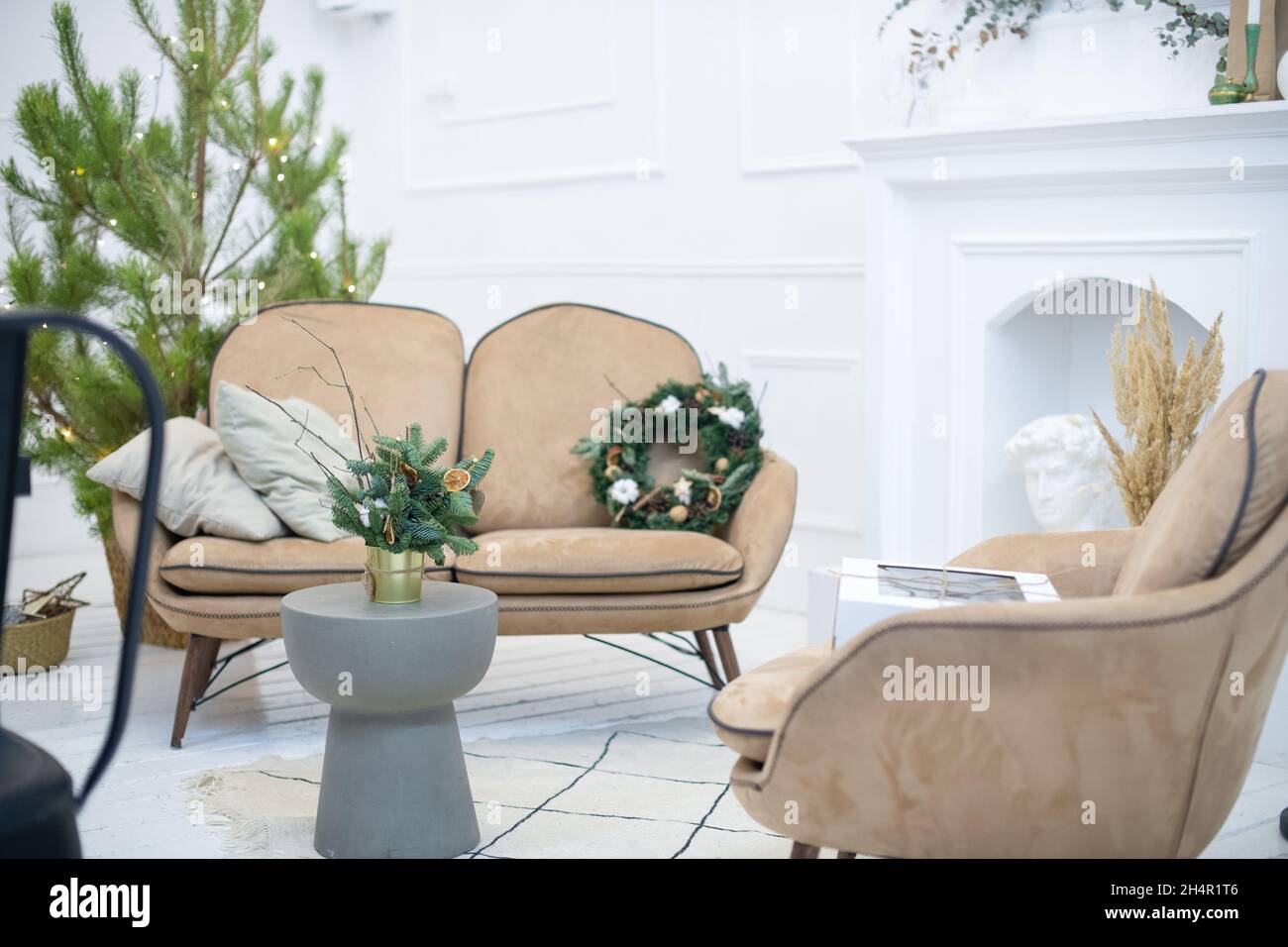 Bellissimo appartamento accogliente con un albero naturale di Natale decorato per Natale. Corona naturale di Natale. Interni scandinavi. Foto Stock