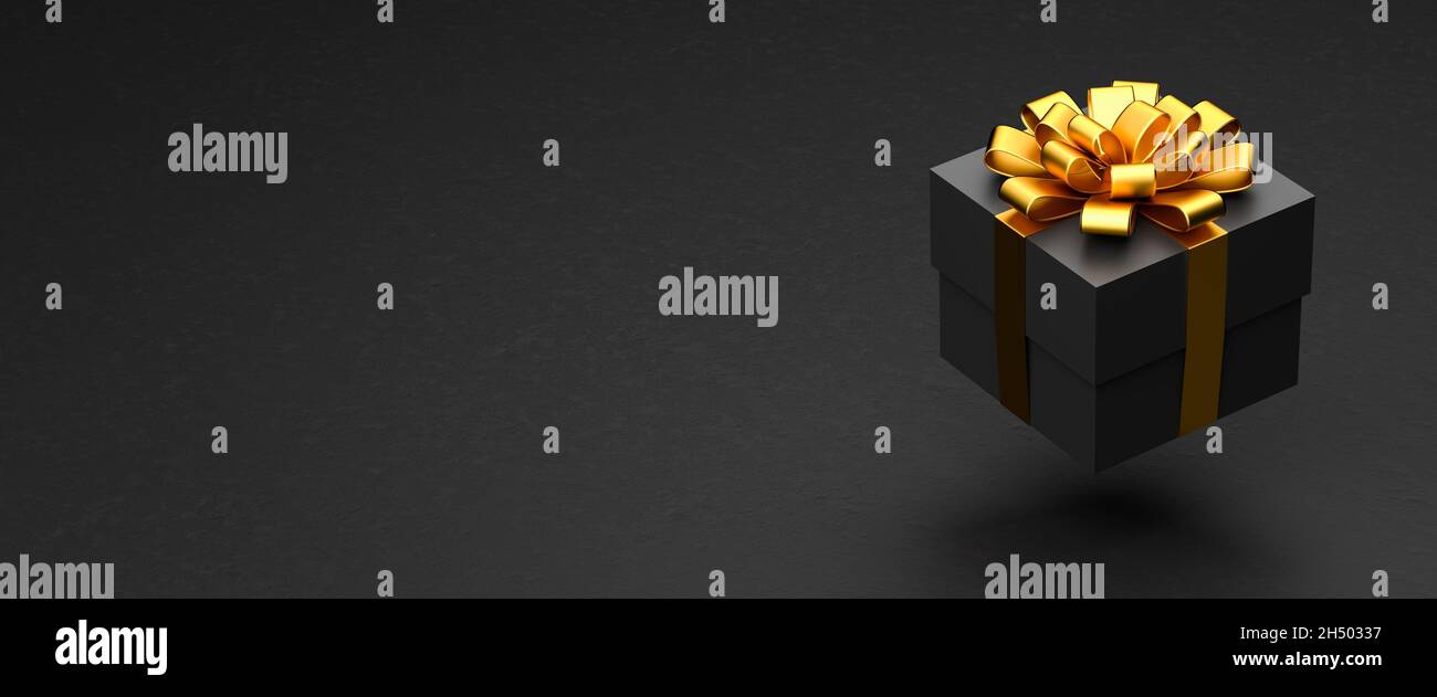 Una scatola presente scura con nastro dorato e arco che si sovrappone ad uno sfondo di pietra nera. Spazio di copia - dimensione banner Web Foto Stock