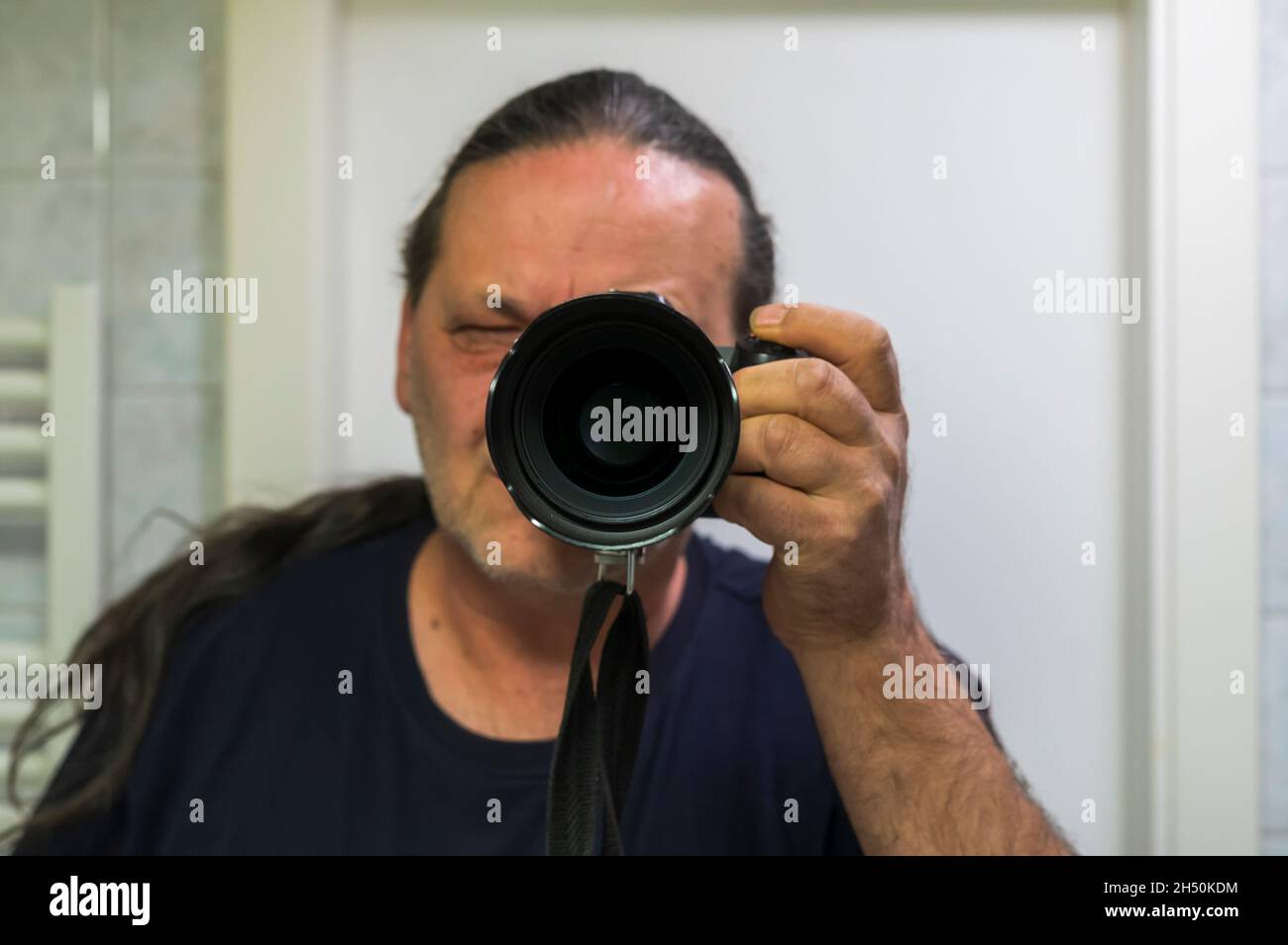 Un uomo scatta una foto di se stesso nello specchio Foto Stock