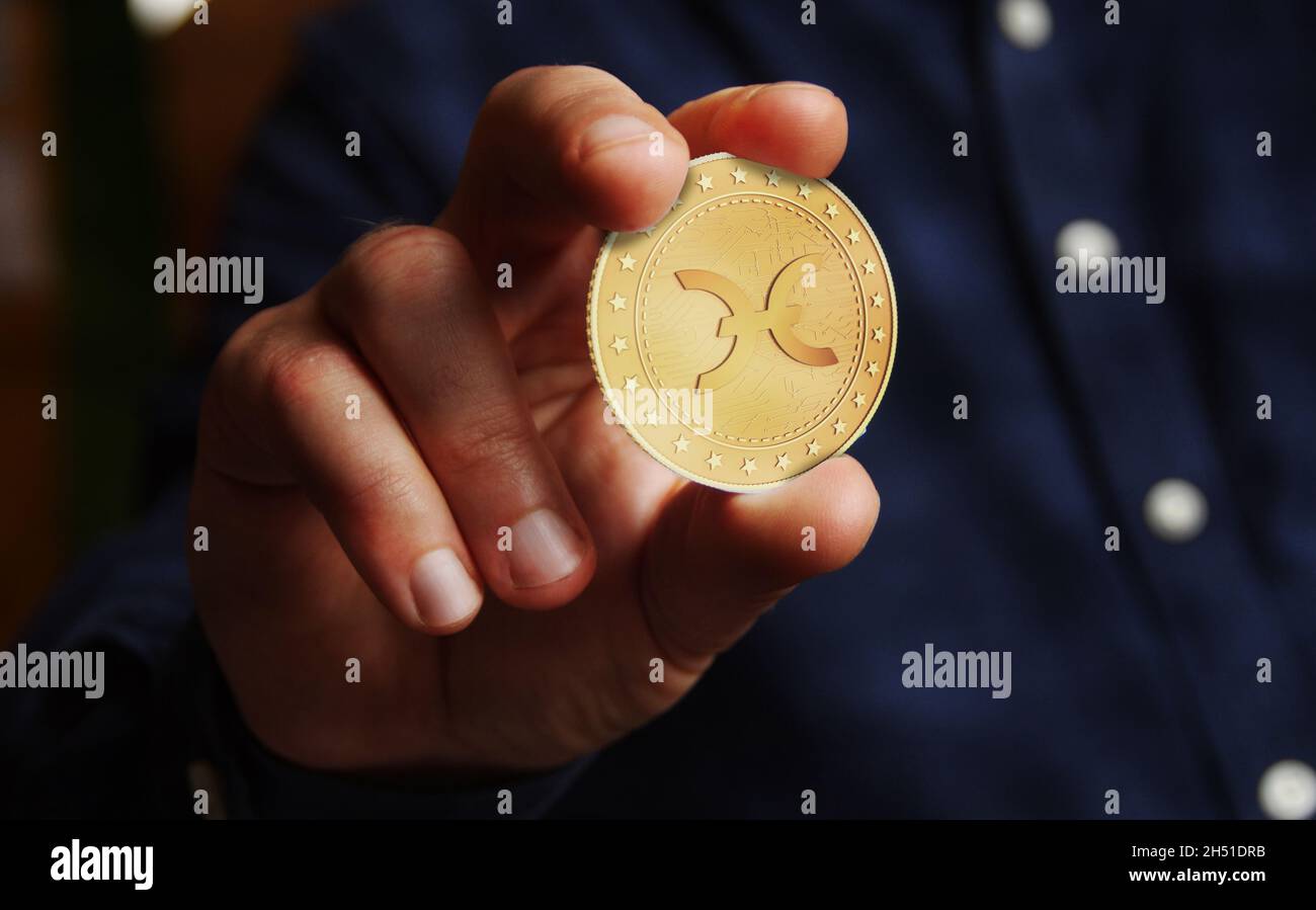 Holocain Holo CALDO criptocurrency simbolo moneta d'oro in mano astratto concetto. Foto Stock