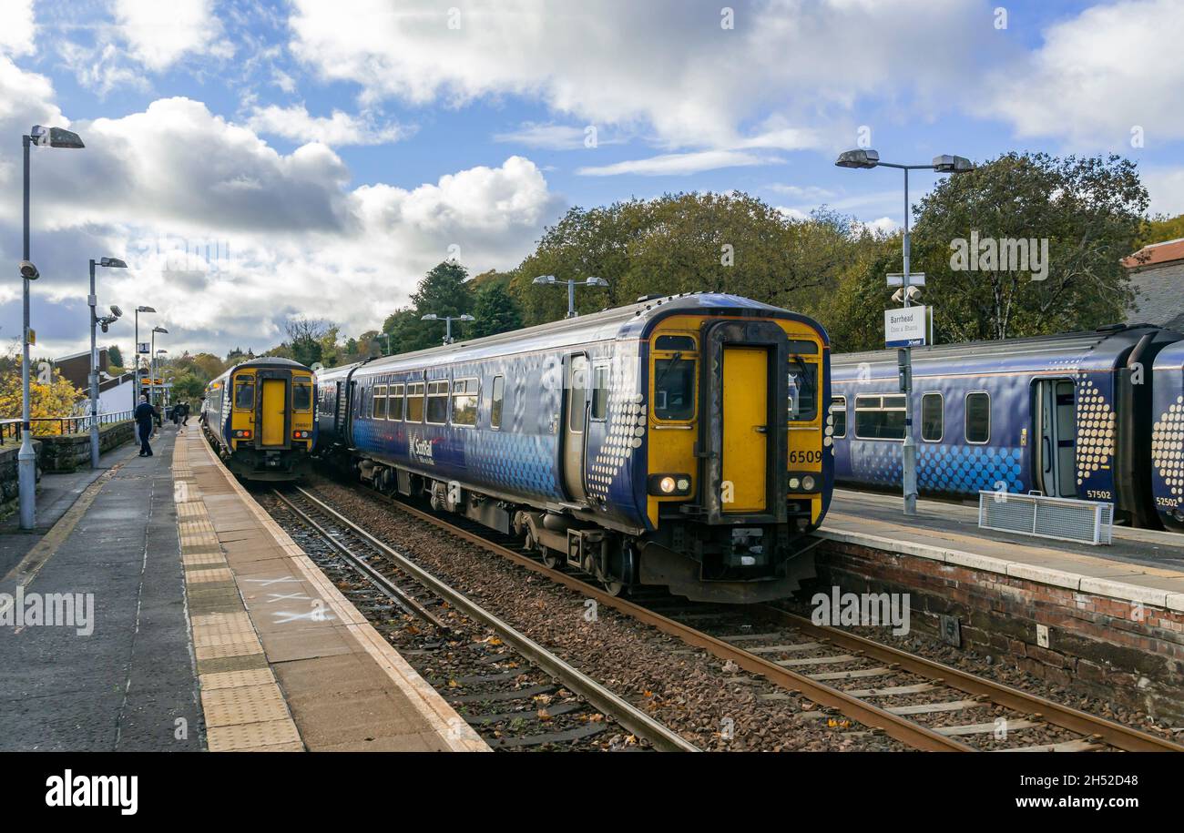 1325 partenza Classe 156 e 1323 Classe 156 Scottrail DMU presso la stazione ferroviaria di Barrhead in Scozia Regno Unito con 1327 Classe 156 proprio per Glasgow Foto Stock