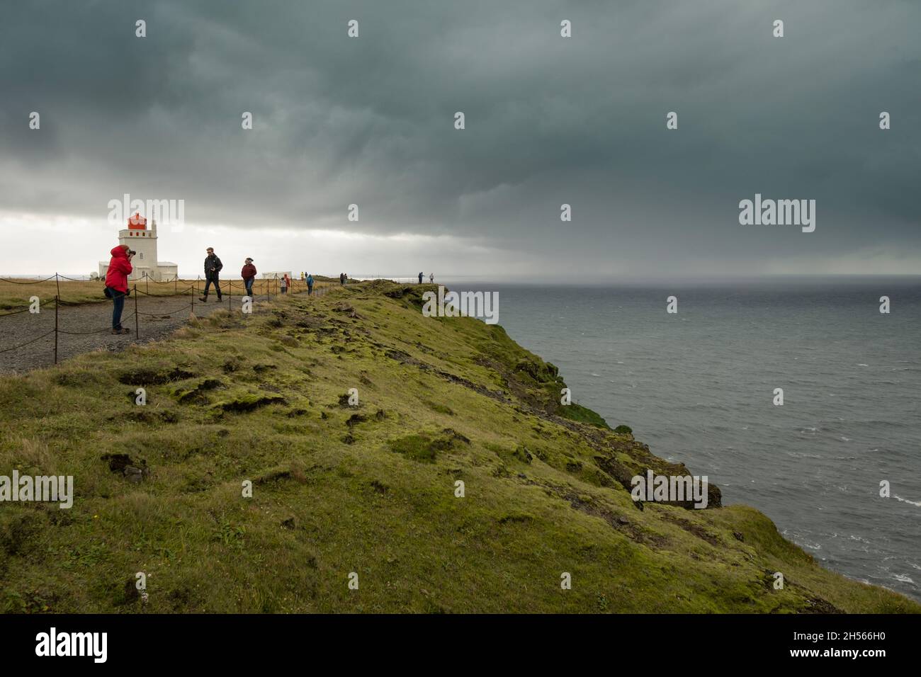Fotografo che scatta foto dell'oceano in condizioni di tempesta Foto Stock