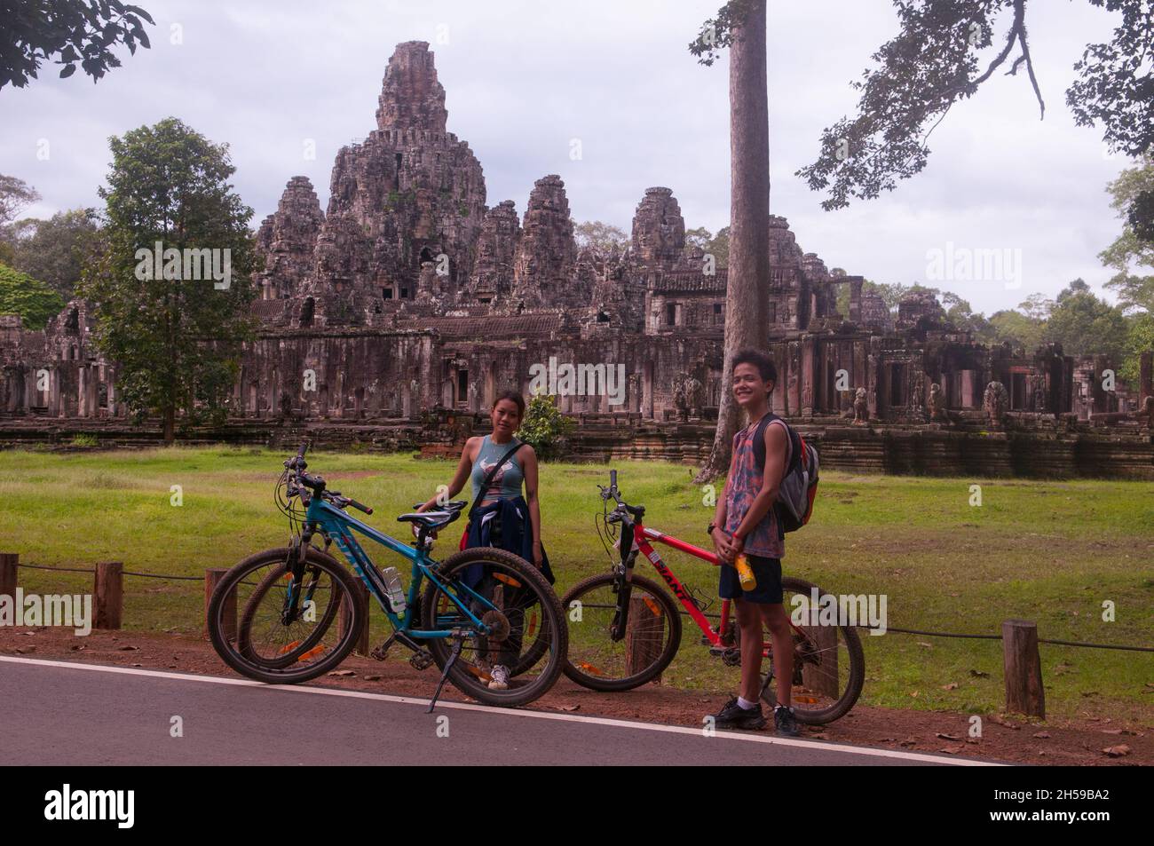 Corsa mista famiglia mountain bike vicino al Bayon durante il coronavirus pandemic. Angkor Thom, Parco Archeologico di Angkor, Provincia di Siem Reap, Cambogia. 18th ottobre 2021. © Kraig Lieb Foto Stock