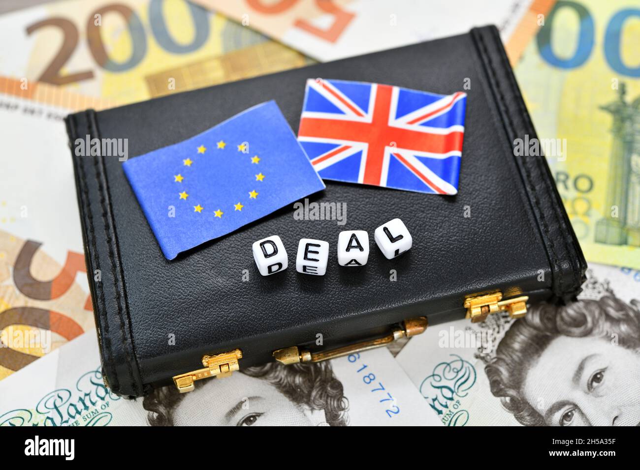 Aktenkoffer mit den Fahnen der Europäischen Union und Großbritannien dem Schriftzug Deal auf Geldscheinen, Symbolfoto Brexit Foto Stock