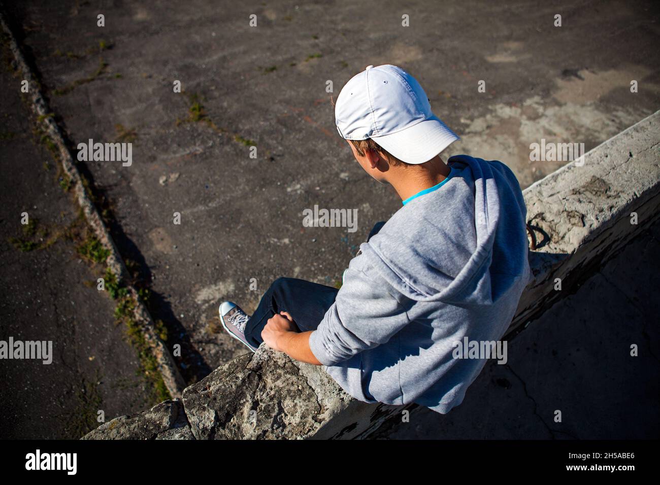 Depresso Teenager siediti sul tetto dell'edificio Foto Stock