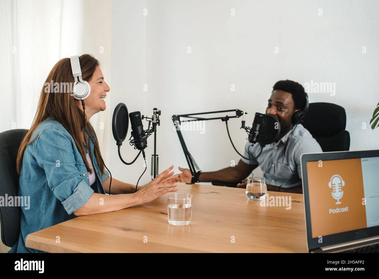 Colleghi multietnici che registrano podcast in studio Foto Stock