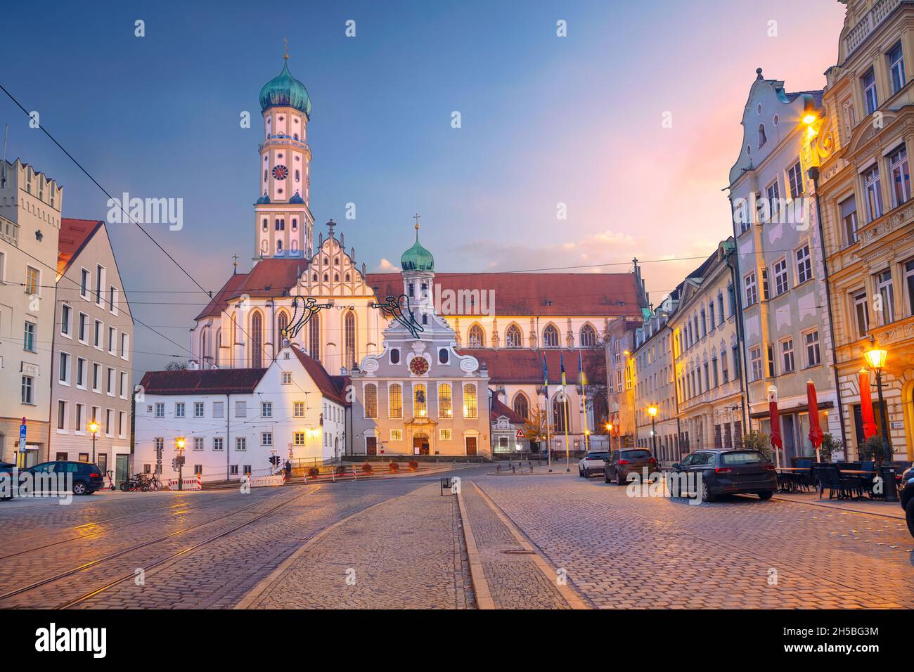 Augusta, Germania. Immagine del paesaggio urbano della strada della città vecchia di Augusta, Germania, con la Basilica di San Ulrich e Afra al tramonto d'autunno. Foto Stock