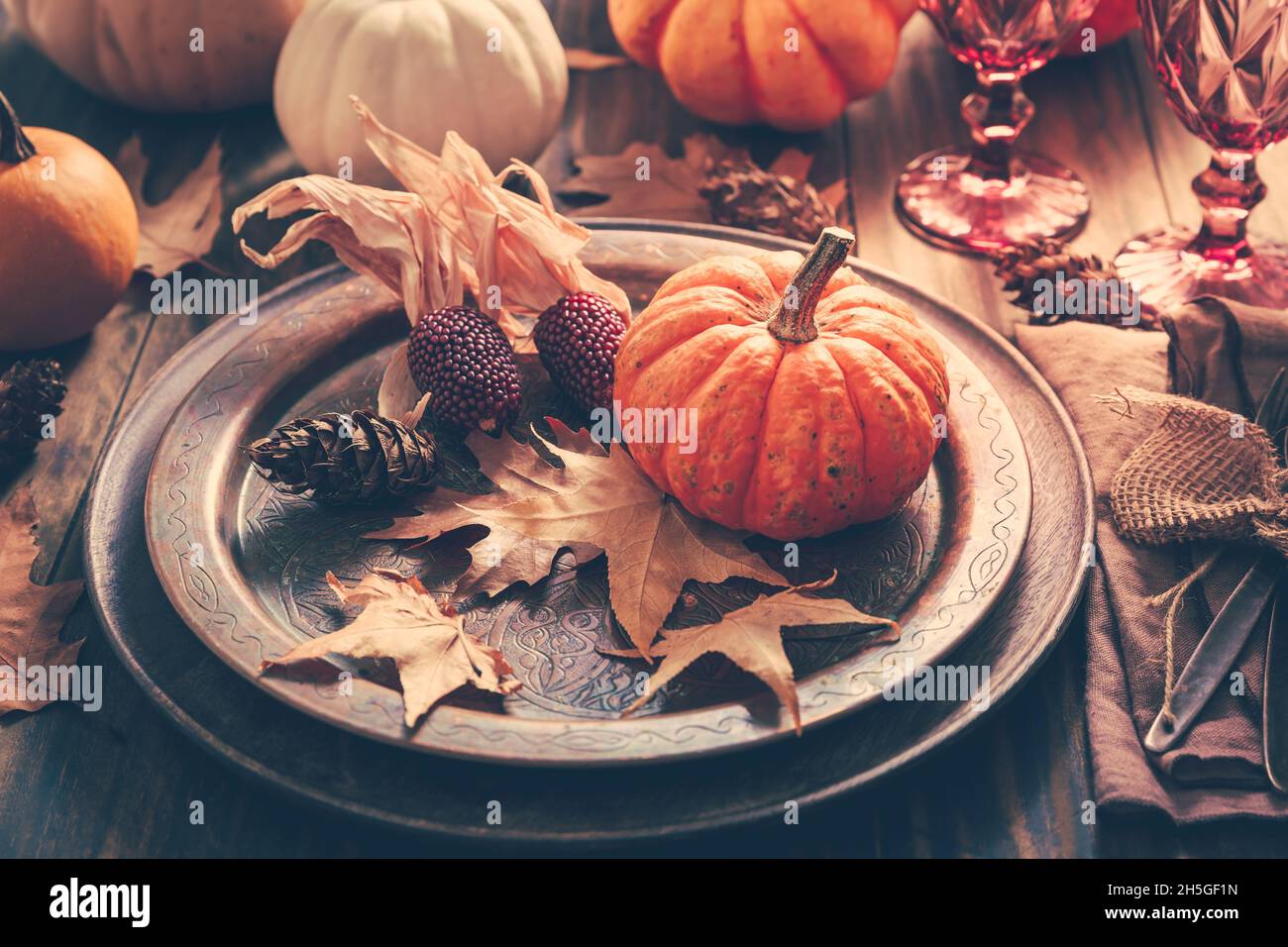 Luogo per il Ringraziamento con zucche e foglie d'autunno in stile vintage Foto Stock