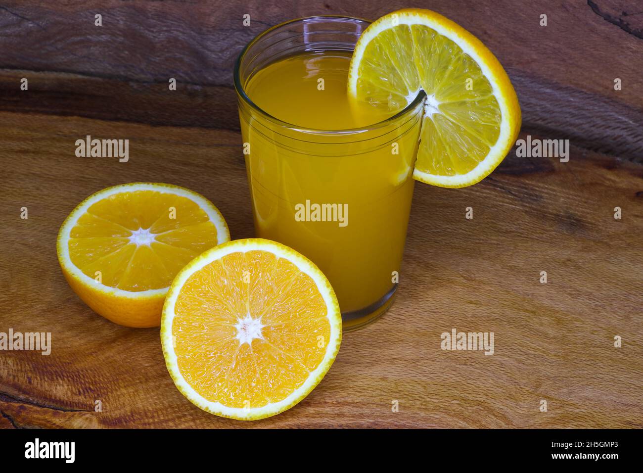 Bicchiere di succo fresco con fetta di Valencia frutta arancione (Citrus x sinensis) Foto Stock