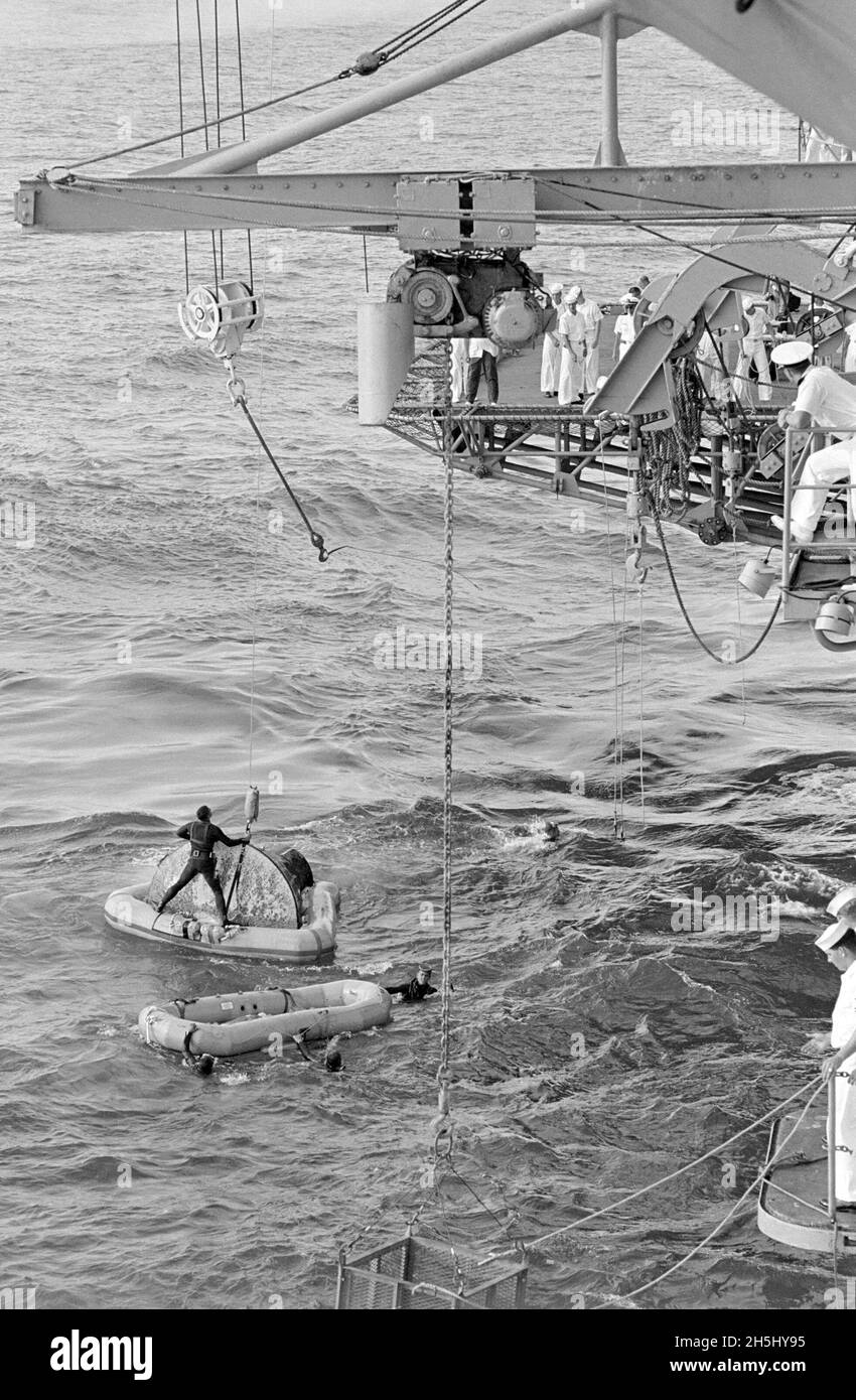(21 luglio 1966) --- la navicella spaziale Gemini-10, con il collare di galleggiamento ancora attaccato, è pronta per il sollevamento a bordo della nave di recupero principale, USS Guadalcanal. I frogmen della Marina assistono nelle operazioni di recupero. Gli astronauti John W. Young, pilota di comando, e Michael Collins, pilota, equipaggio principale per il semaforo spaziale Gemini-10, erano già stati prelevati in elicottero e volati verso il Guadalcanal. Gemini-10 ha abbattuto 460 miglia nautiche ad est di Cape Kennedy alle 16:07 (EST), 21 luglio 1966, per concludere una missione di tre giorni nello spazio. Foto Stock