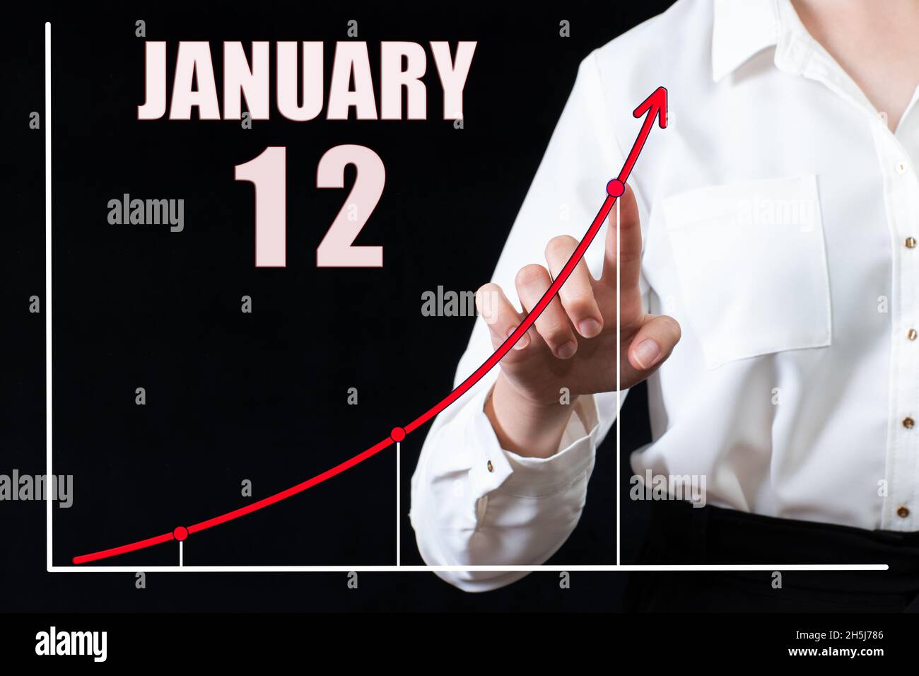 12 gennaio. La mano di una donna d'affari indica il grafico e un calendario con la data del 12 gennaio. Obiettivi aziendali per il giorno. Mese invernale, Foto Stock