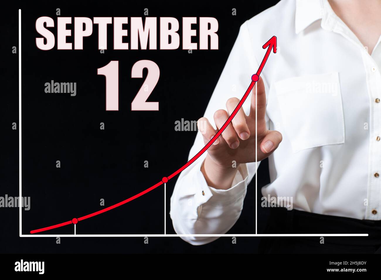12 settembre. La mano di una donna d'affari indica il grafico e un calendario con la data del 12 settembre. Obiettivi aziendali per il giorno. Autunno mo Foto Stock