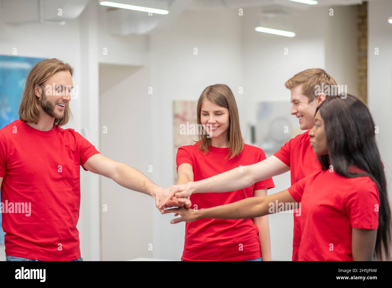 Squadra di giovani volontari in maglietta rossa Foto Stock