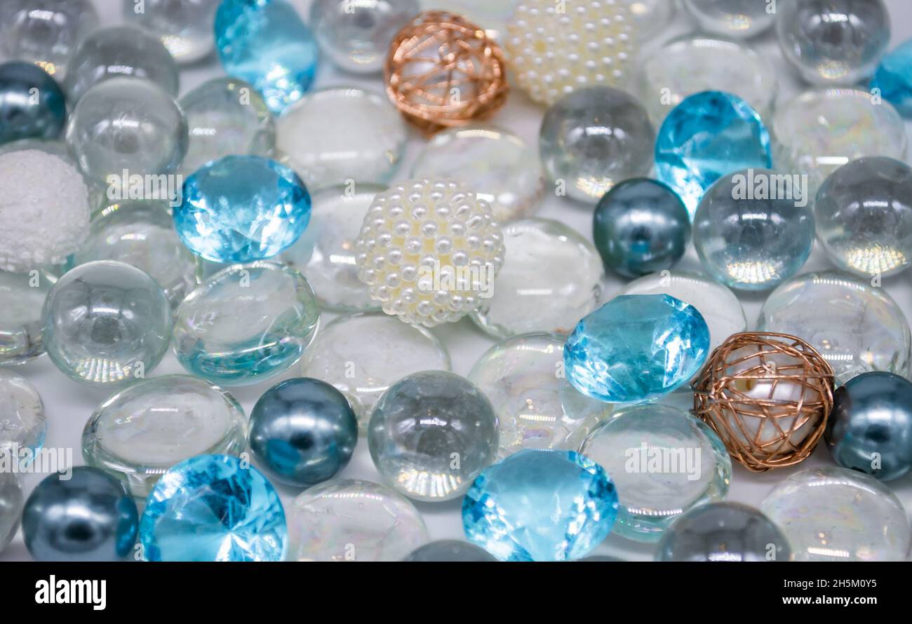 Bellissimo sfondo di perle di vetro blu chiaro, trasparenti e perle bianche. Spazio di copia. Foto Stock