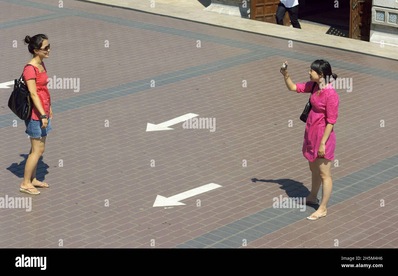 Due turisti asiatici femmine che si scattano foto ricordo l'uno dell'altro a Istanbul, Turchia Foto Stock