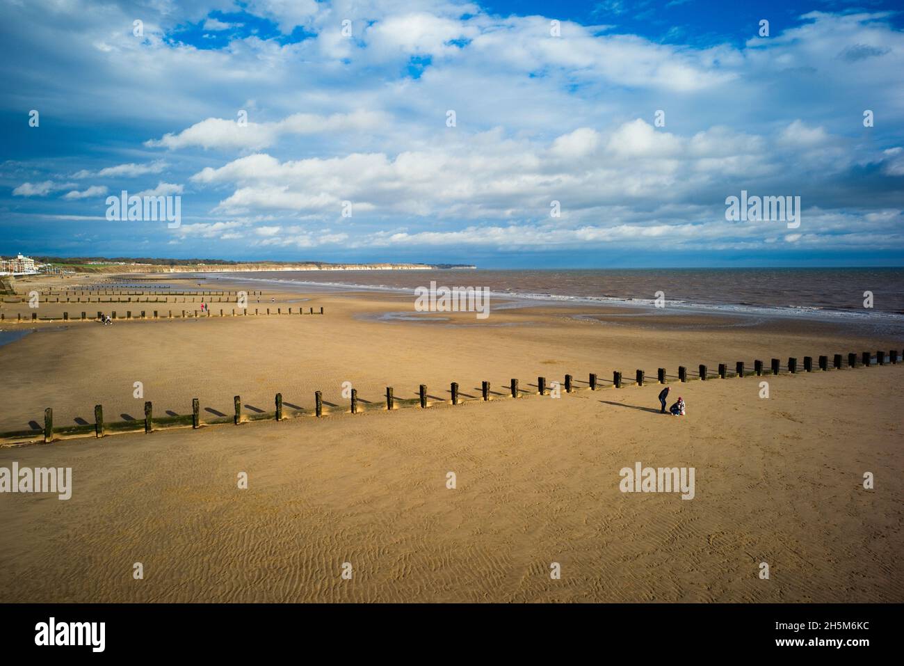 Una famiglia sulle sabbie del nord che prende un gruppo girato alla bassa marea a Bridlington Foto Stock