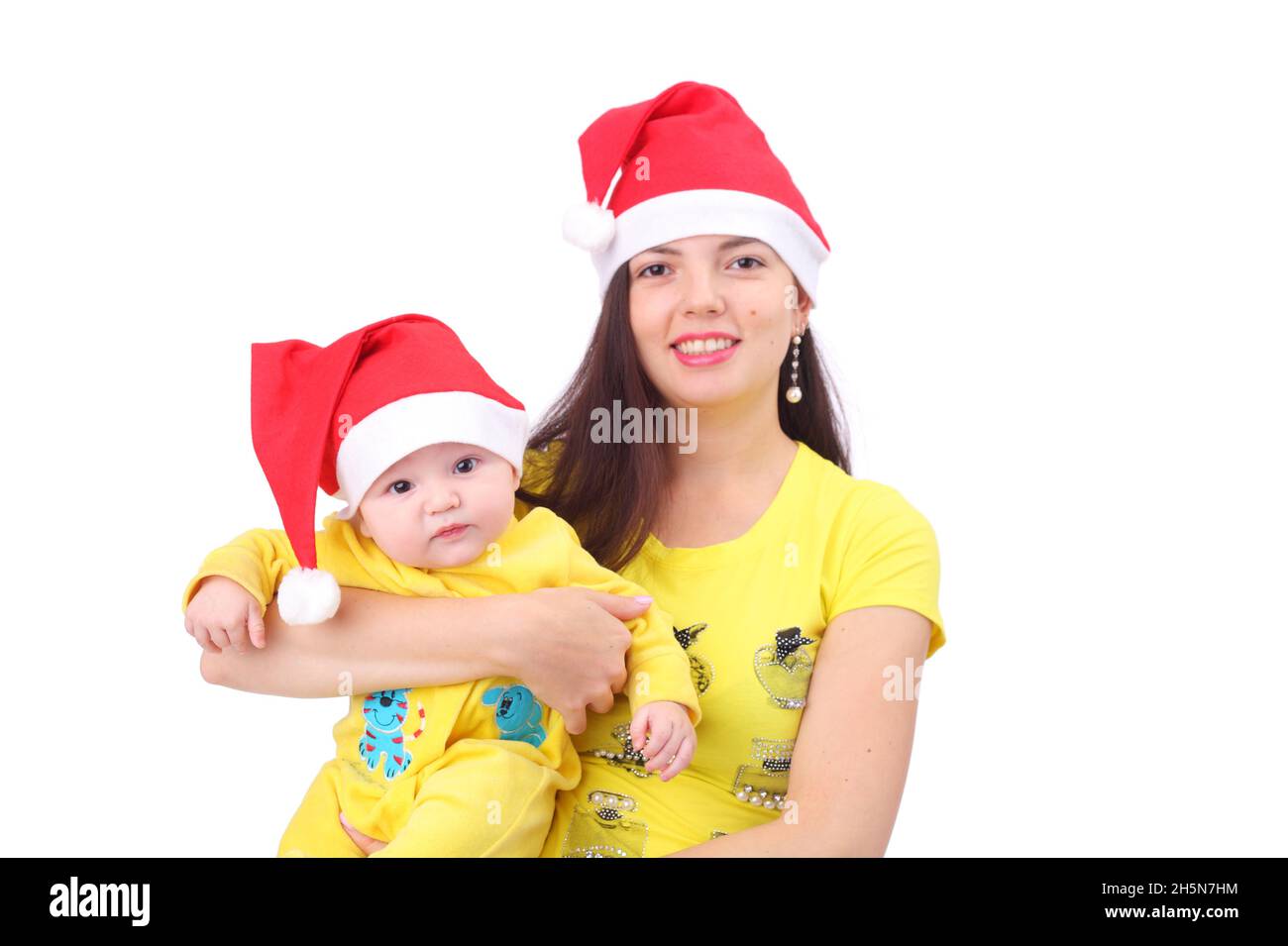 La famiglia di Capodanno indossa i tappi rossi di Natale Foto Stock