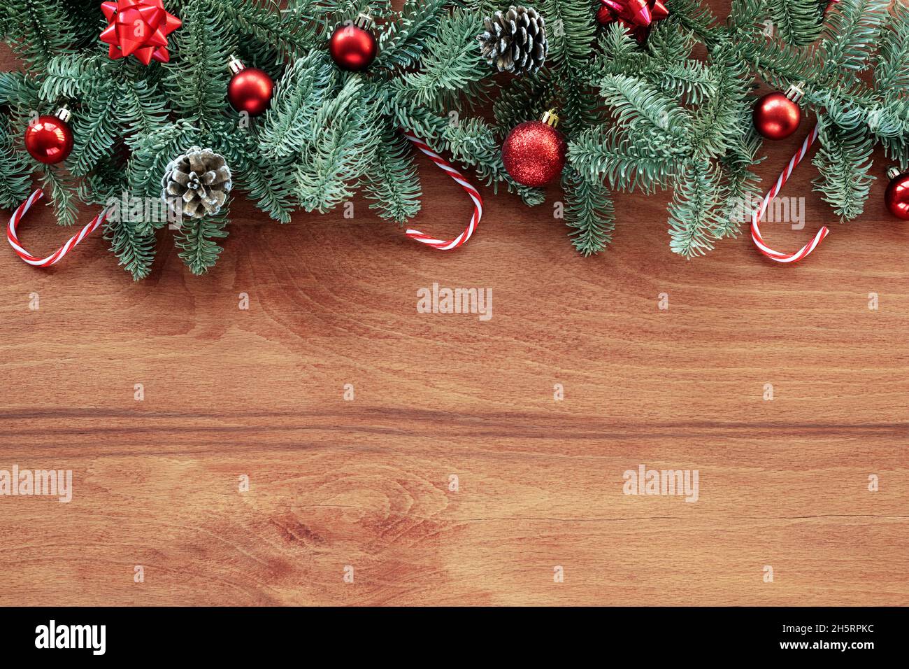 Sfondo natalizio con rami di abete, decorazioni di Capodanno su sfondo in legno. Vista dall'alto, disposizione piatta, spazio di copia Foto Stock