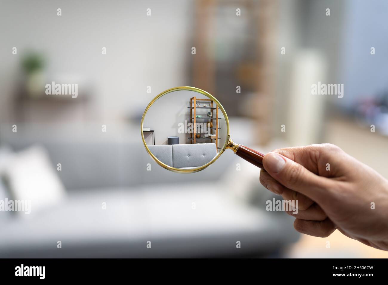 Home Property Inspection Concept with Person Holding Magnificing Glass Foto Stock