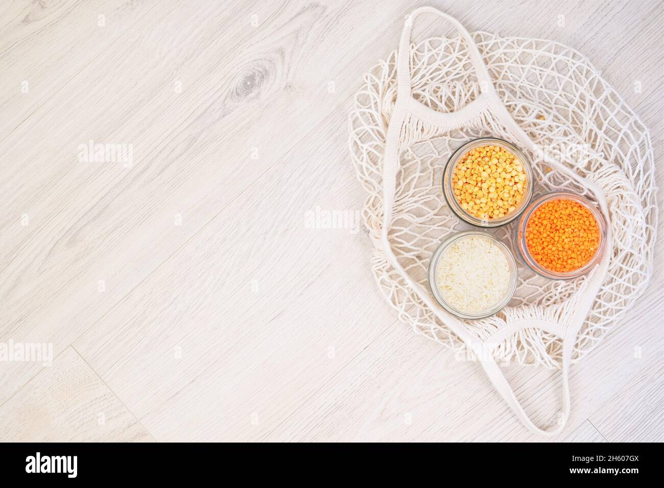 Prodotti biologici alla rinfusa e cereali in un negozio di rifiuti zero. Deposito di alimenti in cucina a basso stile di vita di spreco. Grani in vasetti di vetro su sfondo di legno. Eco Foto Stock