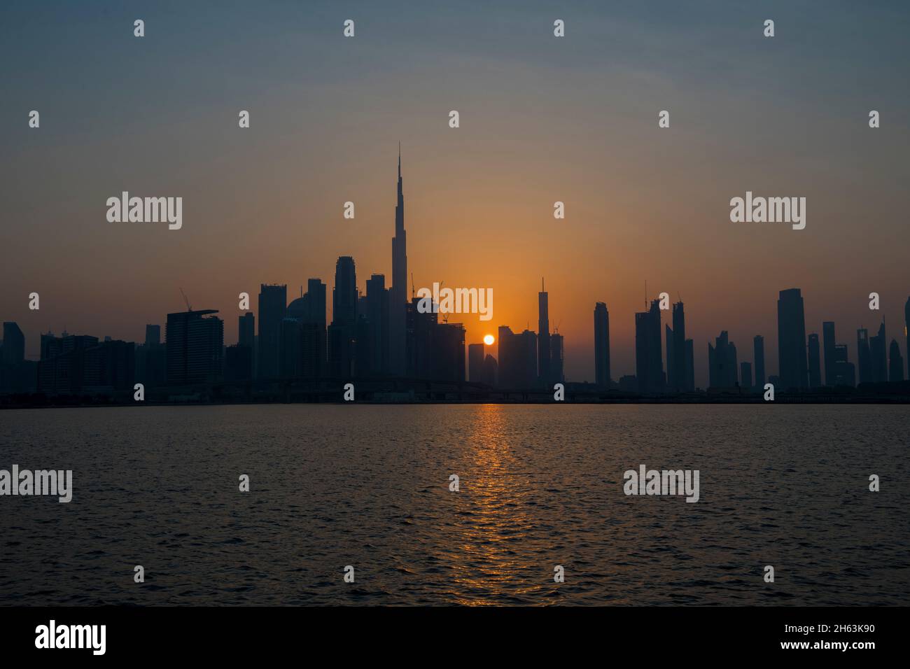 Burj Khalifa e alti edifici al tramonto Dubai Canal UAE Foto Stock