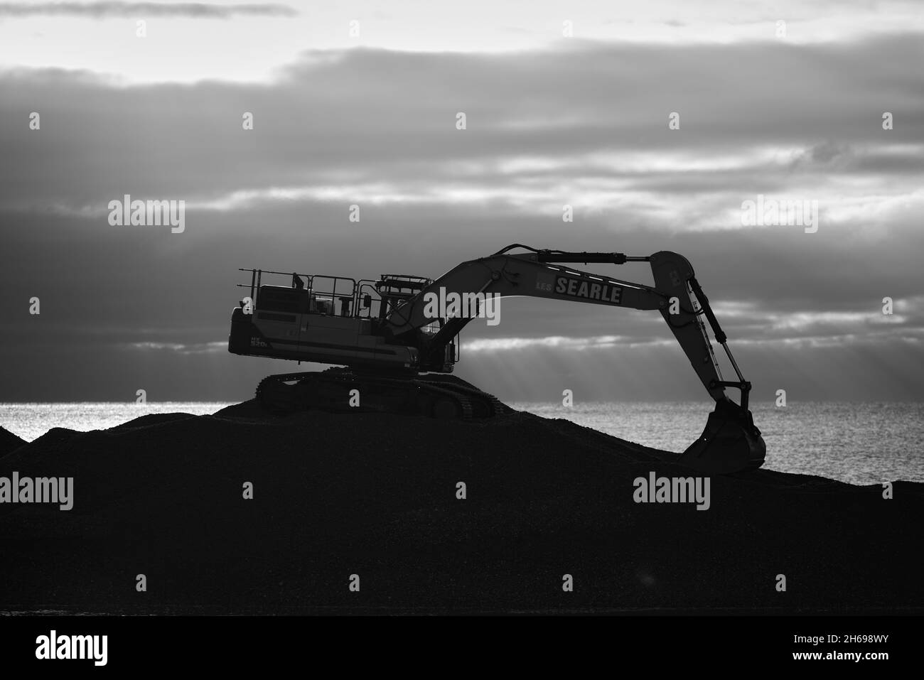 Macchinari pesanti visto lavorare sulla costa. Foto Stock