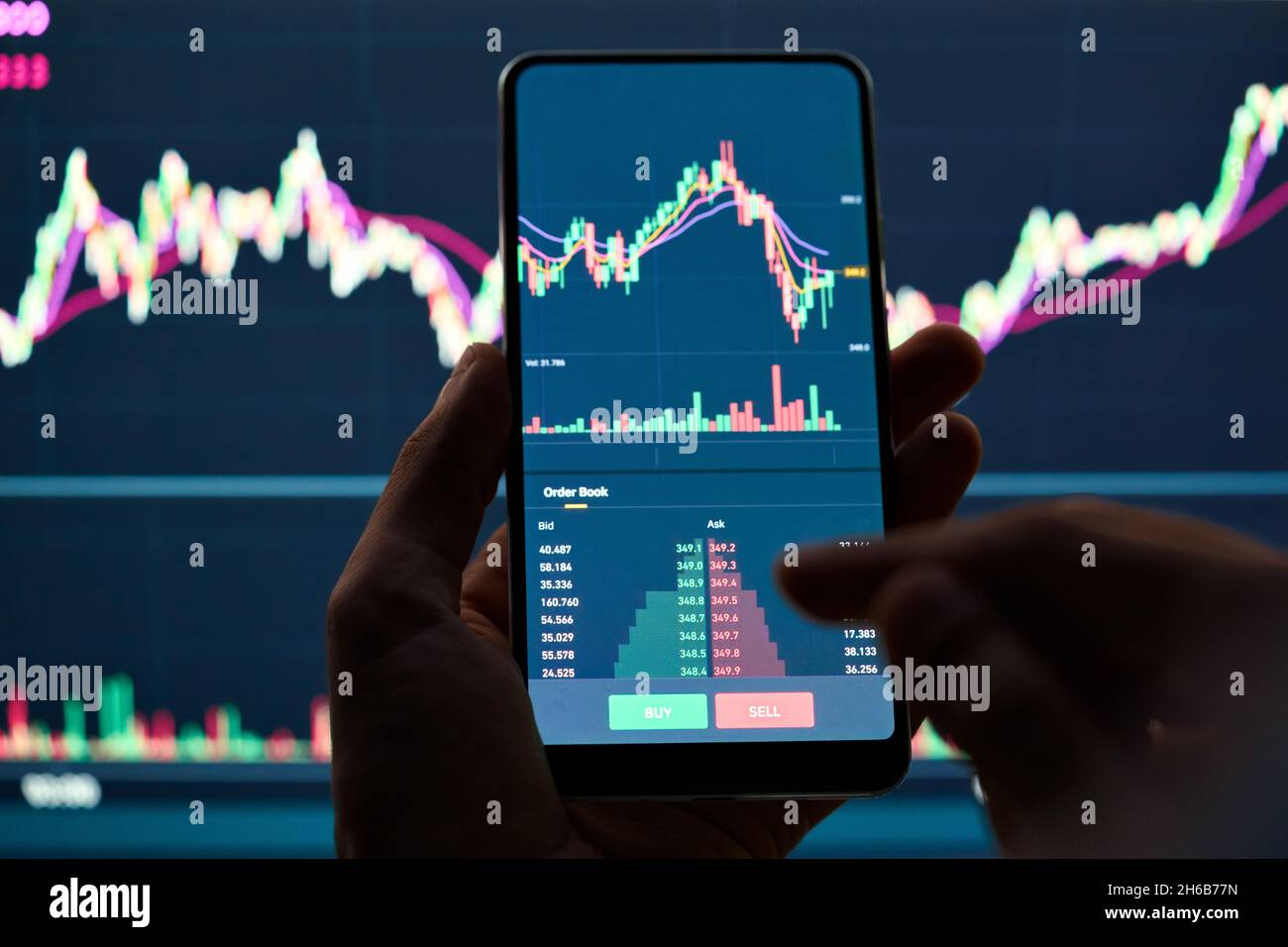 Crypto investitore in possesso di telefono acquistare vendere azioni di negoziazione ordine in app. Foto Stock