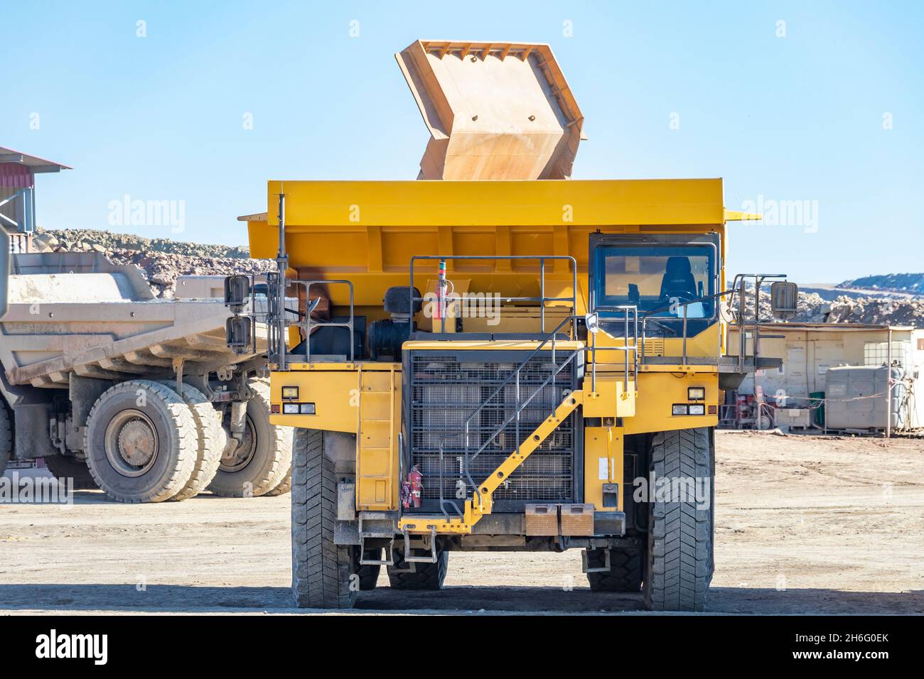 Camion e macchinari minerari a Corta Atalaya miniera aperta buca. Scavi profondi di pirite ed estrazione di minerali di cooper e oro in comune di Foto Stock