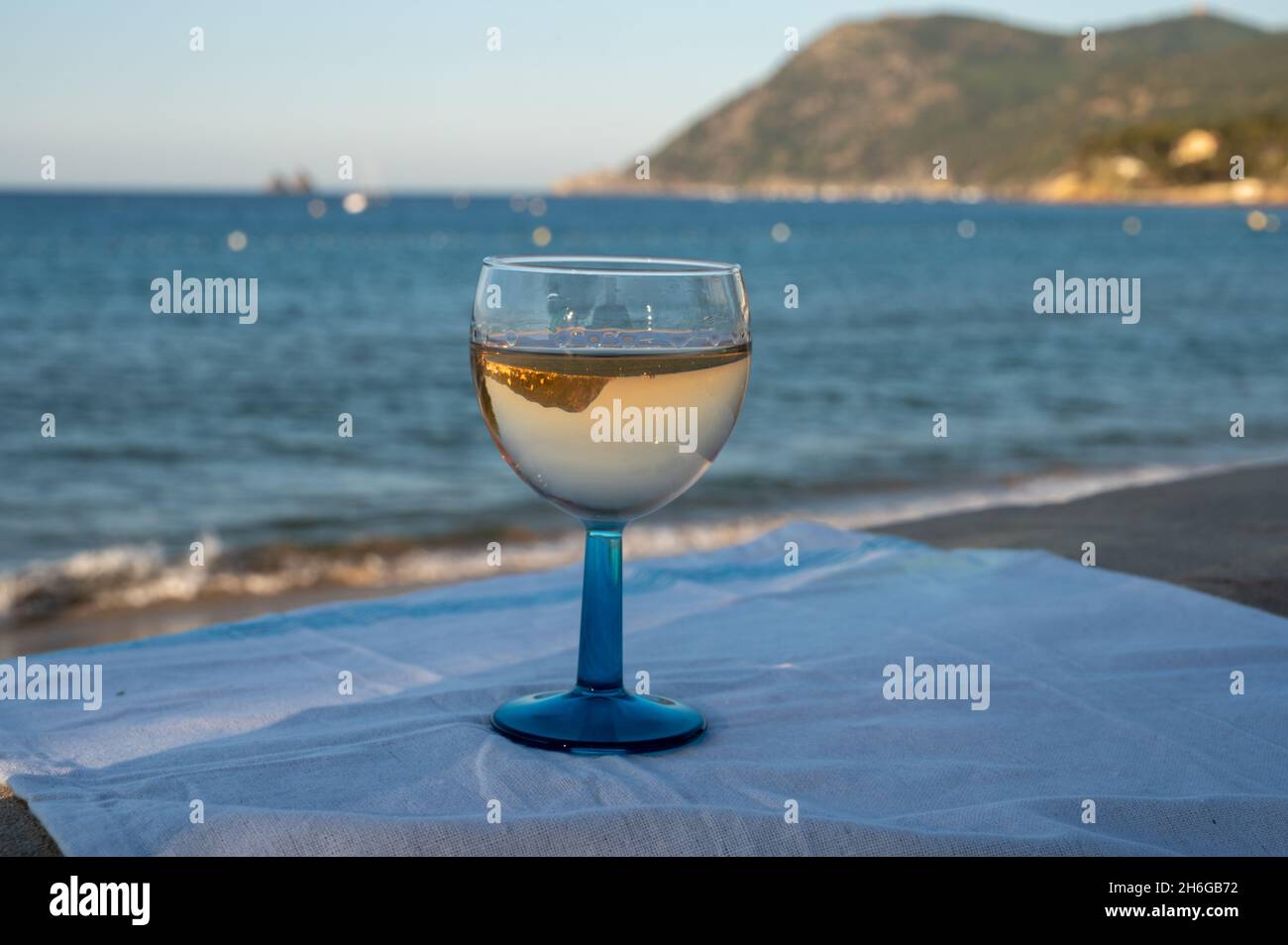 Estate in Provenza, bere di vino rosato secco freddo gris sulla spiaggia di sabbia e mare blu vicino Tolone, dipartimento del Var, Francia Foto Stock