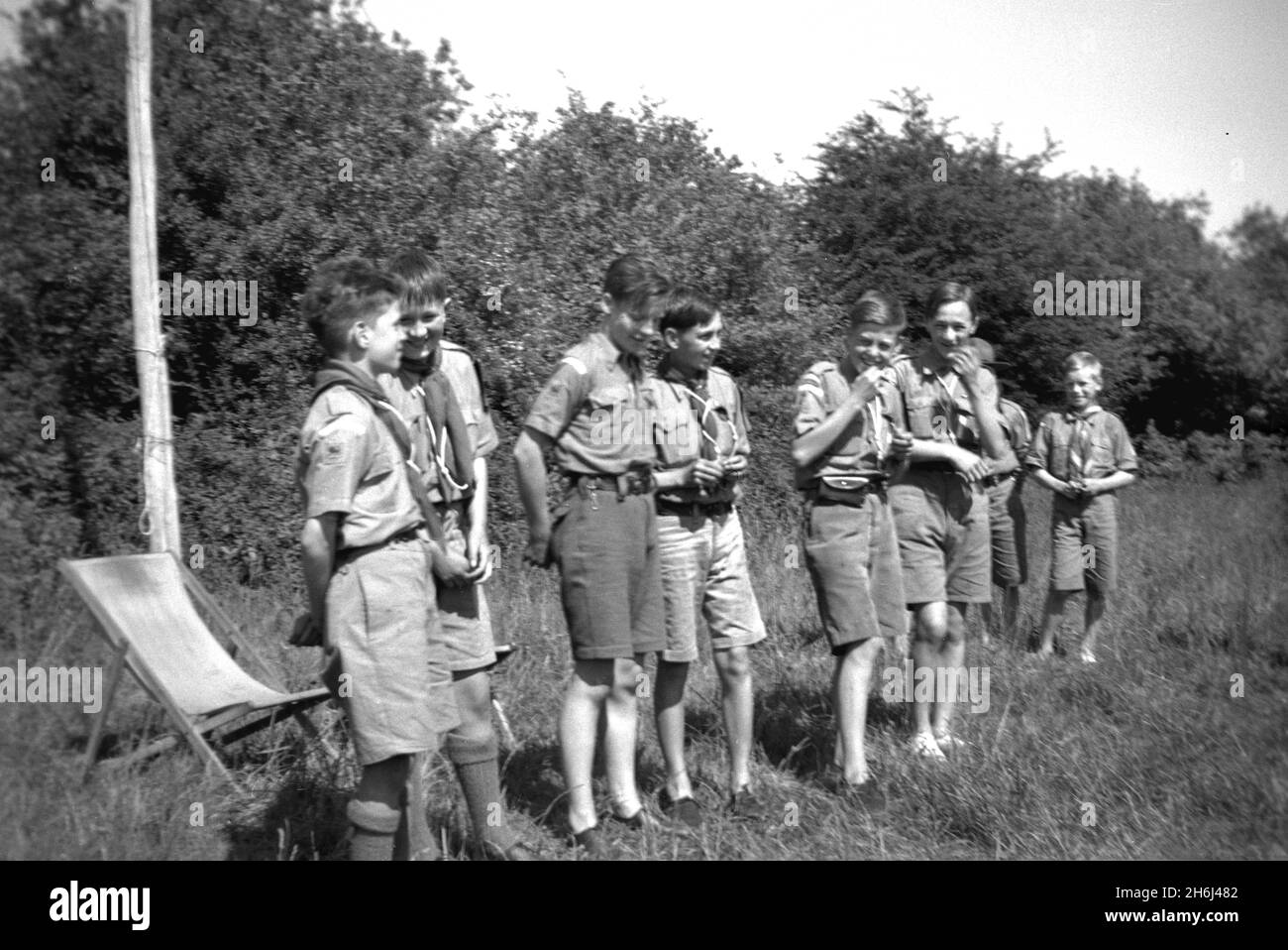 1939, al di fuori di un campo, i ragazzi del 13esimo Purley scouts truppa nelle loro uniformi che hanno una risata insieme al campo per l'Adkin Challenge Trophy, Inghilterra, Regno Unito. Lo scouting iniziò nel 1908, dopo che il generale Robert Baden-Powell aveva tenuto un campo sperimentale sull'isola di Brownsea, Poole Harbour, l'estate precedente. Circa 20 ragazzi vi hanno partecipato e sono stati insegnati una serie di abilità all'aperto, tra cui monitoraggio, vigili del fuoco, realizzazione di rifugi da rami, annodamento, cucina, salute e igiene, salvavita e pronto soccorso. Il famoso libro di Baden-Powell, 'Scouting for Boys', è stato pubblicato nel 1908. Foto Stock