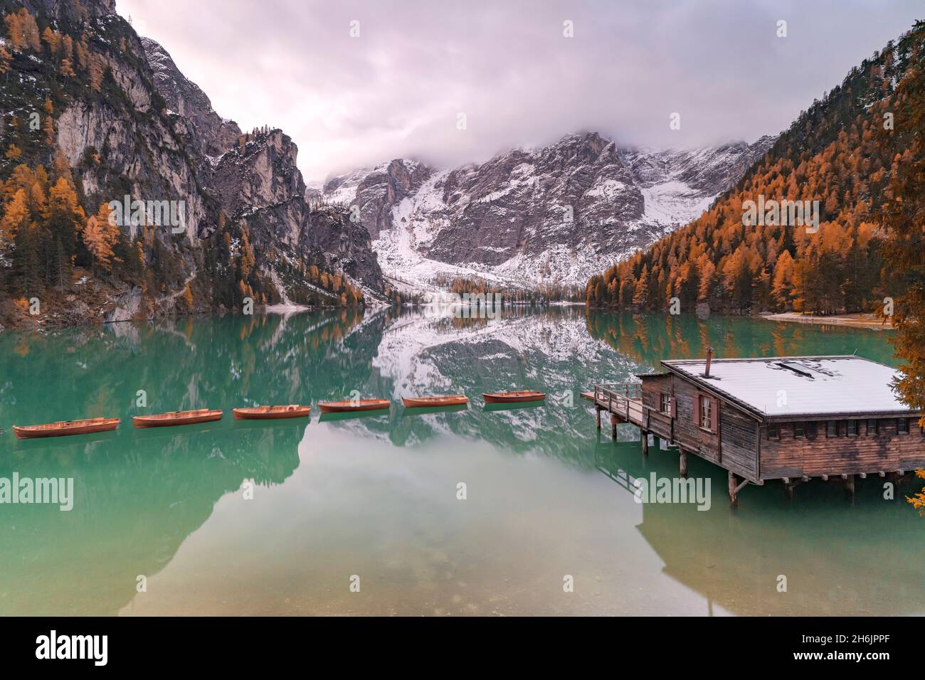 Lago di Braies (Pragser Wildsee) incorniciato da boschi colorati in autunno, Braies (Praga, provincia di Bolzano, Alto Adige, Italia, Europa Foto Stock