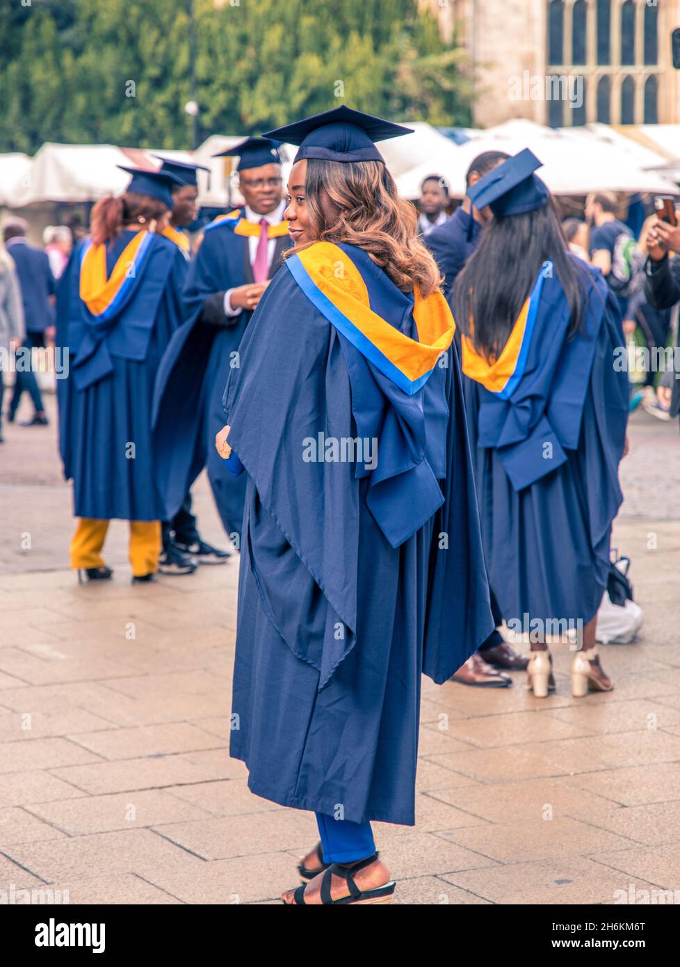 Gli studenti dell'Anglia Ruskin University si sono accaniti con abiti colorati e cappe quadrate durante le celebrazioni di laurea a Cambridge in Inghilterra Foto Stock