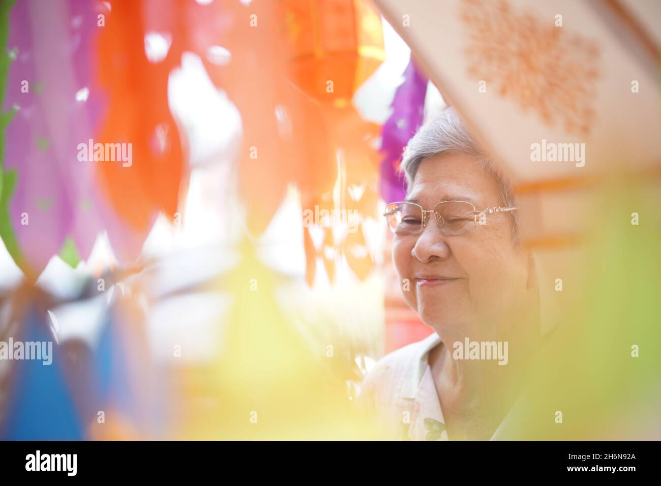 anziano asiatico anziano anziano anziano che prega con lanterna di carta Foto Stock