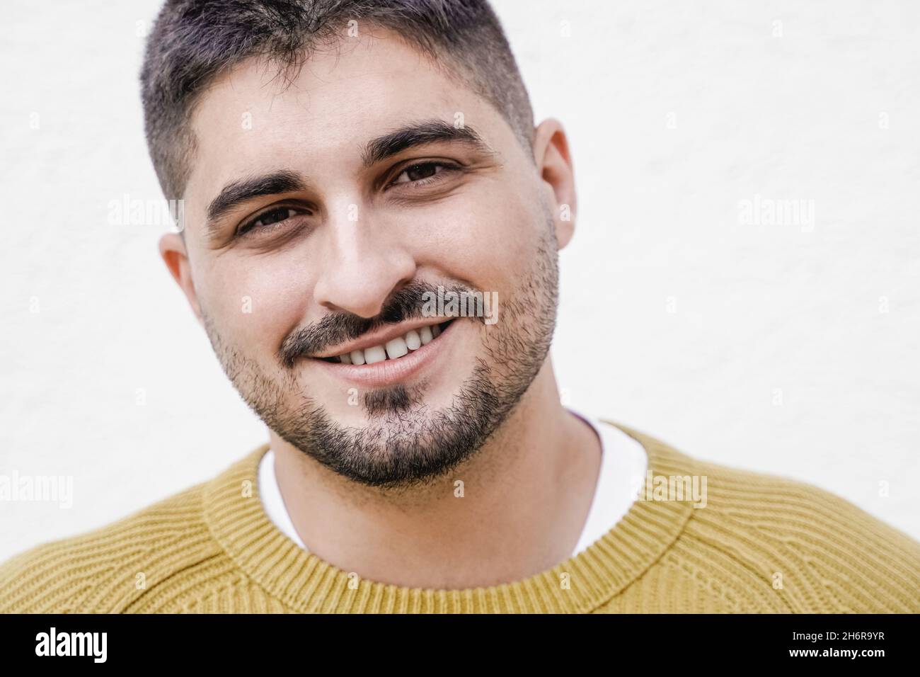 Giovane uomo arabo sorridente con la fotocamera - Focus on Face Foto Stock