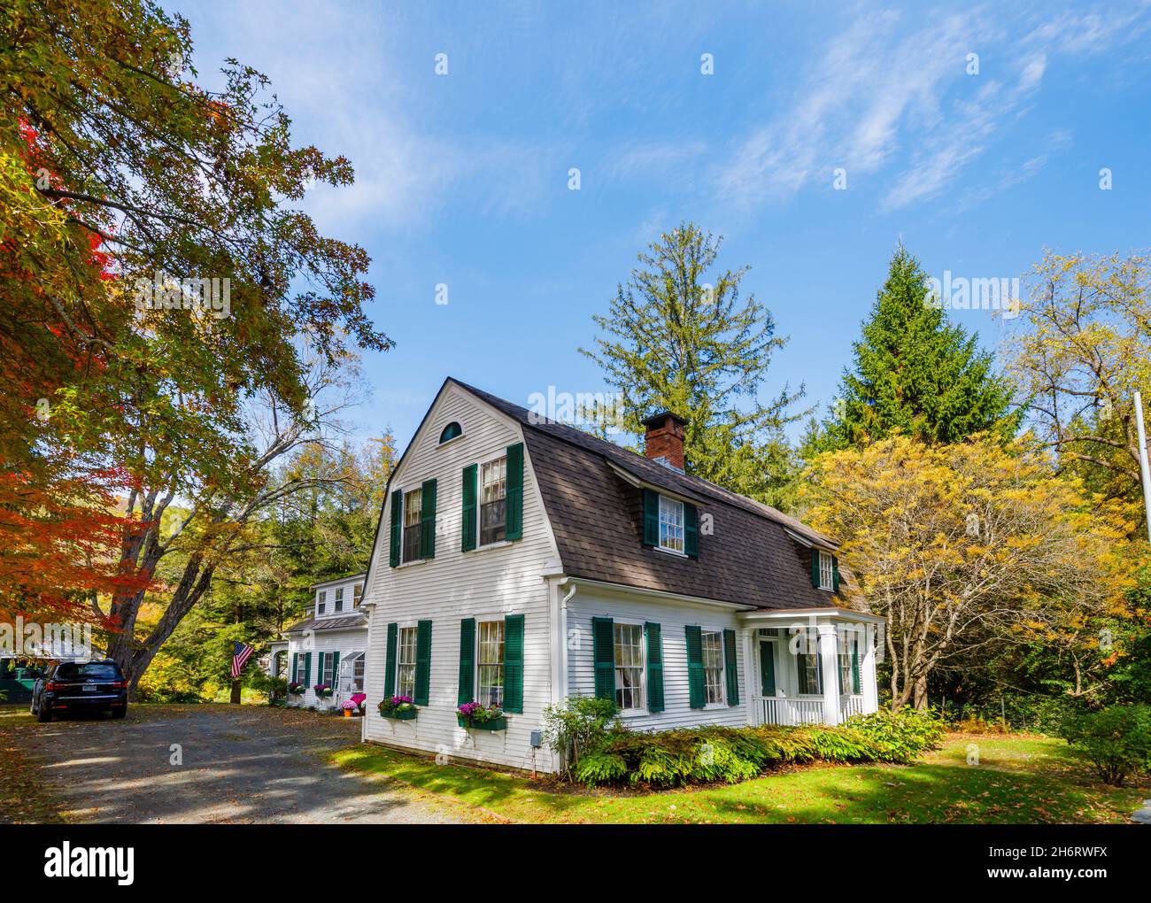 Tipico stile locale grande casa di fronte a lavagna bianca con bandiera patriottica americana a Woodstock, Vermont, New England, USA Foto Stock