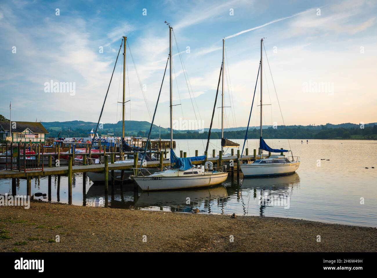 Waterhead, vista su una serata estiva di barche ormeggiate lungo il molo di Waterhead, un porto sulla riva nord del lago Windermere, Cumbria, Inghilterra Regno Unito Foto Stock