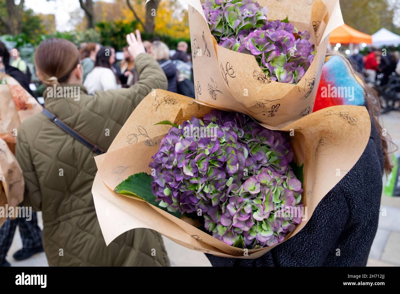 Columbia Road Flower Market persone che acquistano piante fiori in strada al mercato bancarelle Domenica nel novembre 2021 East London UK KATHY DEWITT Foto Stock