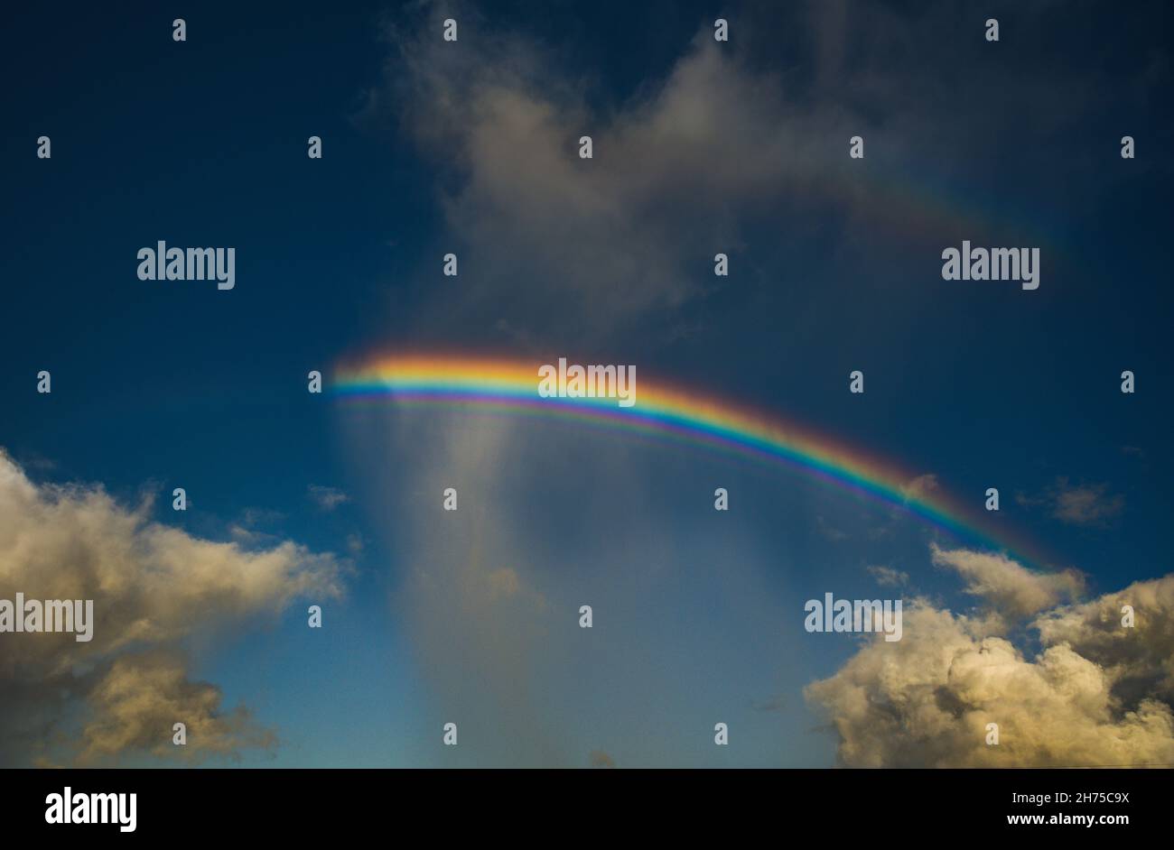 Un arcobaleno angelico, riflessione, dispersione e rifrazione della luce che passa attraverso una doccia nel cielo, che si inarcano tra due nuvole, Kunia, Hawaii, USA Foto Stock