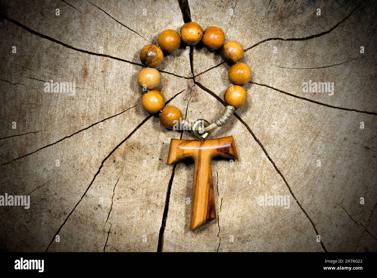 Tau, croce di legno a forma di lettera t (simbolo religioso di San  Francesco d'Assisi) con perla rosaria. Su una sezione trunk ad albero Foto  stock - Alamy
