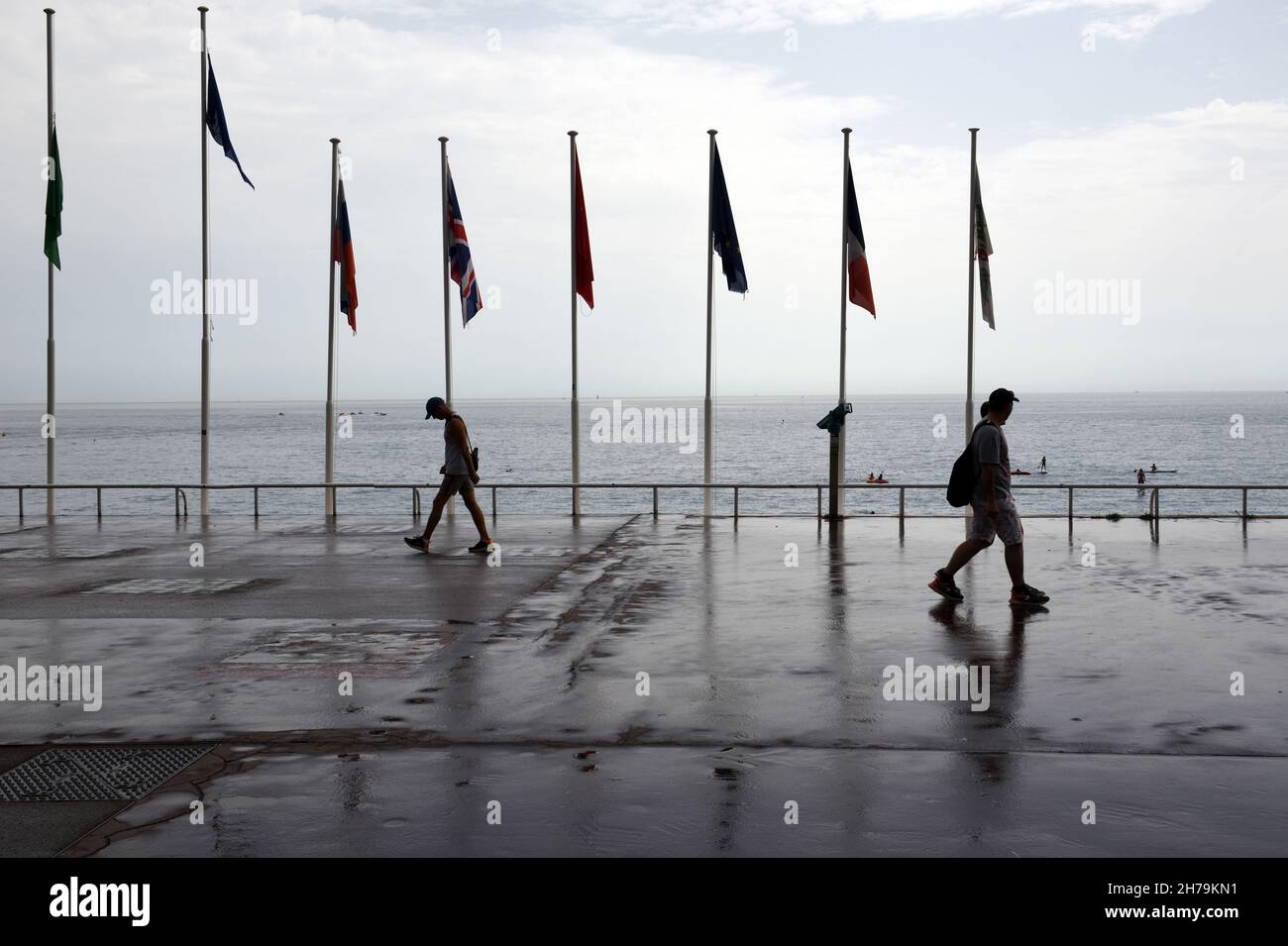 Pedoni in un giorno di pioggia o bagnata sulla Promenade des Anglais Nice Alpes-Maritimes Francia Foto Stock
