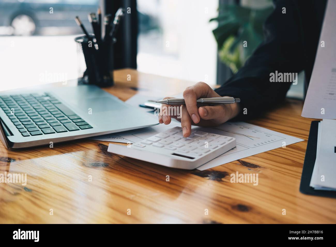 Primo piano un contabile che lavora sul finanziario con calcolatrice presso il suo ufficio per calcolare le spese, Accountig Concept Foto Stock